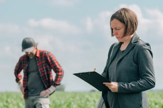 mortgage-loan-officer-assisting-farmer-in-financia-2024-12-06-19-59-31-utc-2